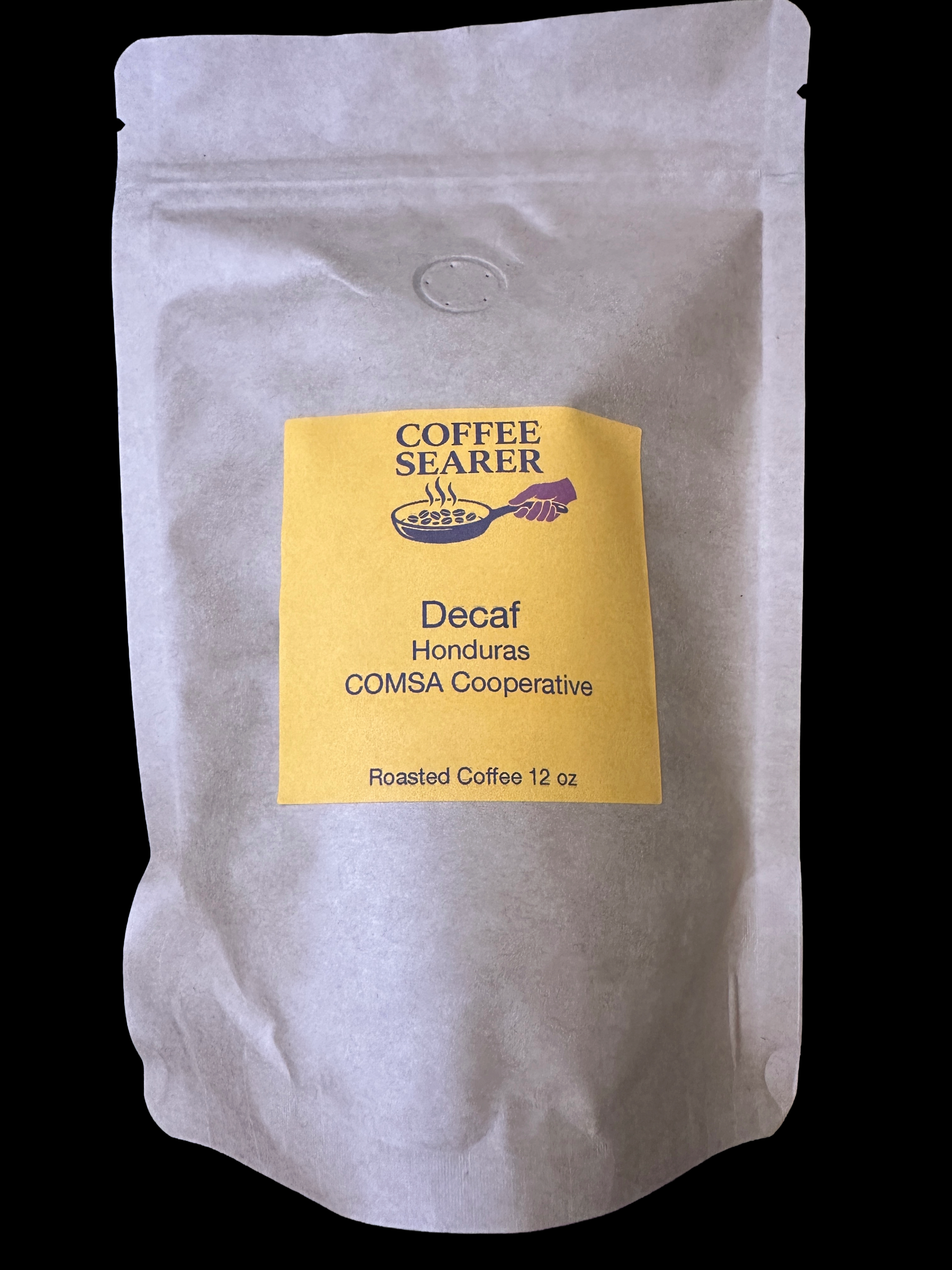 A 12 oz stand-up pouch of Coffee Searer Decaf Honduras coffee, featuring a yellow label on a white textured background, set against a solid black backdrop.