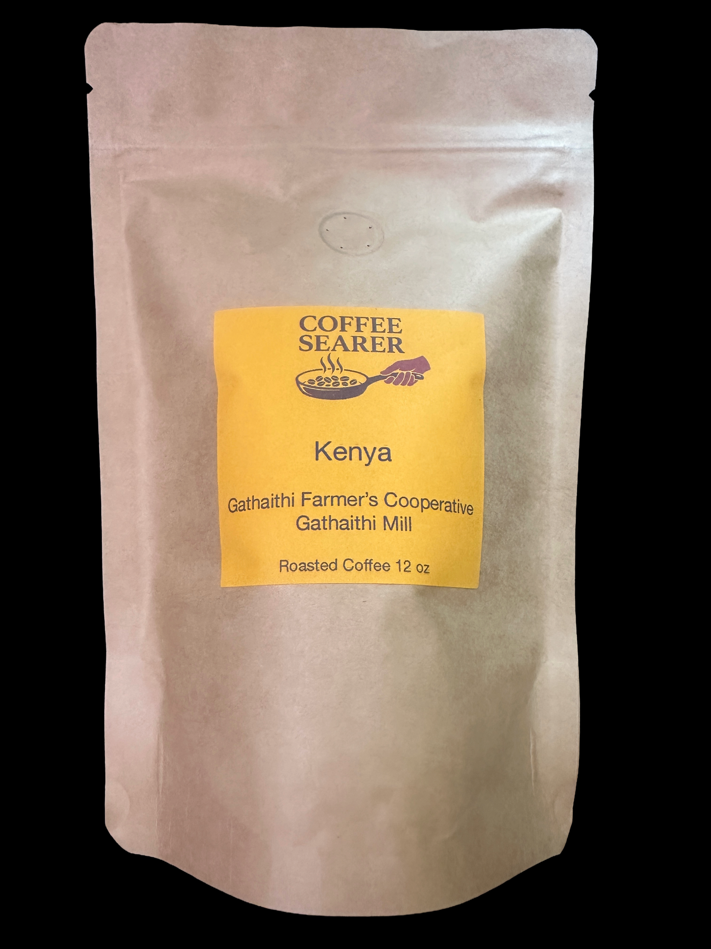 A 12 oz stand-up pouch of Coffee Searer Kenya roasted coffee, featuring a beige kraft paper pouch with a bright yellow label on a solid black background.